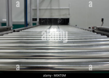 The conveyor chain, and conveyor belt on production line set up in clean room area. Stock Photo