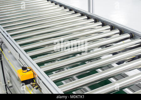 The conveyor chain, and conveyor belt on production line set up in clean room area. Stock Photo