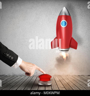 Businessman launches rocket pushing a red button. 3D Rendering Stock Photo