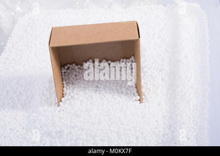 Box on little  white polystyrene foam balls Stock Photo