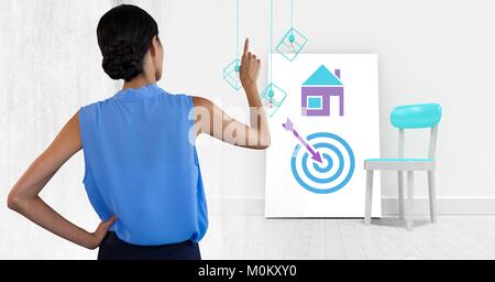 Woman pointing with business icons on white board Stock Photo