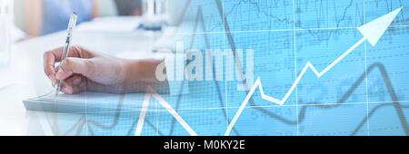 Hand writing with graph overlays Stock Photo
