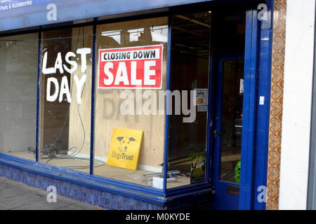 Shop on high street in Brentwood Essex displaying closing down sale signs on store front window. Stock Photo