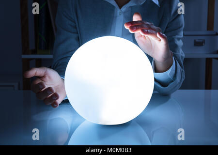 Portrait Of A Afro American Businesswoman Hand On Crystal Ball In Office Stock Photo