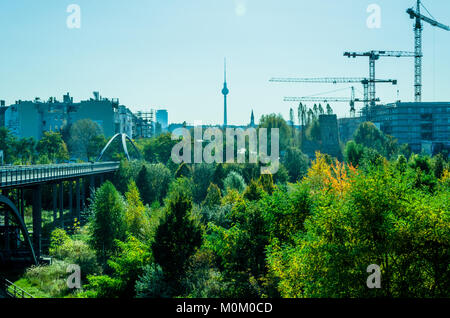 Berlin boom - construction crane and green panorama with television tower. Scene seen from Prenzlauer Berg. Stock Photo