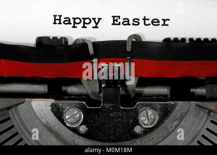 Text Happy Easter written with the old typewriter on white sheet Stock Photo