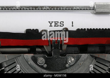 YES written with the old typewriter on white sheet Stock Photo