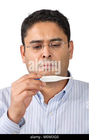 Photo of a middle-aged man looking at thermometer with worry. Stock Photo