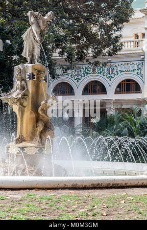 Street view, square, Plaza Gabriel Miro or Correos,fountain and statue sculpture La Aguadora by artist Vicente Bañuls,Alicante,Spain. Stock Photo