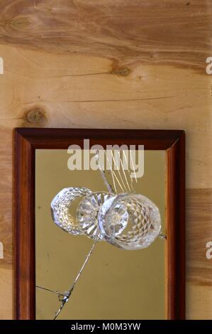 glass cup on broken mirror. Stock Photo