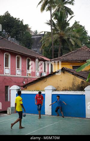 India,Goa,Panjim,children playing football in the middle of the old portuguese colonial houses in Fontainhas district Stock Photo