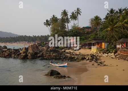 India,Goa,Palolem,boat and colorful houses in front of Colom beach near Palolem beach Stock Photo