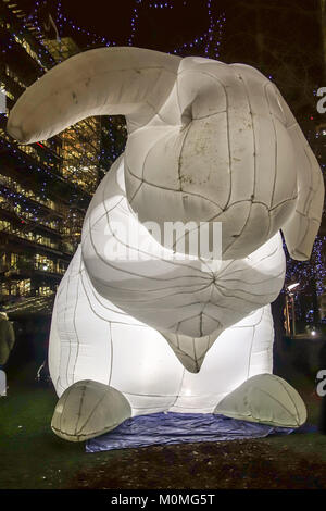 London, UK. 22nd January, 2018. Inflatable white rabbits called Intrude by Amanda Parker highlights Australia's out of control pests but also everyone's childhood fairy stories. They are on display at the Jubilee Park for the Canary Wharf Light Festival 2018. Credit: Fawcitt/Alamy Live News Stock Photo