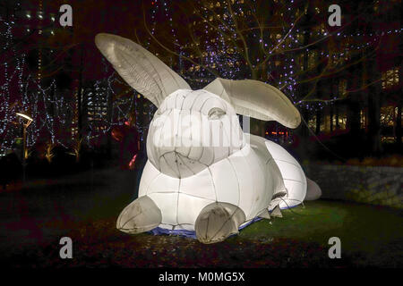 London, UK. 22nd January, 2018. Inflatable white rabbits called Intrude by Amanda Parker highlights Australia's out of control pests but also everyone's childhood fairy stories. They are on display at the Jubilee Park for the Canary Wharf Light Festival 2018. Credit: Fawcitt/Alamy Live News Stock Photo