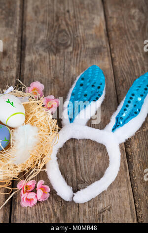 Easter eggs on wooden background. Easter still life with rabbit ears and eggs Stock Photo
