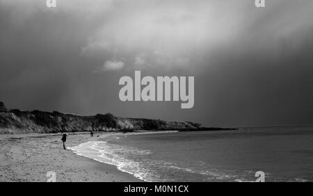 A tourist walks along Towan Beach, near Portscatho on the Roseland Peninsula, in Cornwall, Britain December 29, 2017 Stock Photo