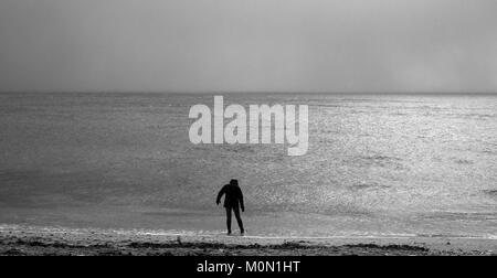 A tourist walks along Towan Beach, near Portscatho on the Roseland Peninsula, in Cornwall, Britain December 29, 2017 Stock Photo