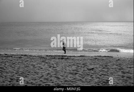 A tourist walks along Towan Beach, near Portscatho on the Roseland Peninsula, in Cornwall, Britain December 29, 2017 Stock Photo