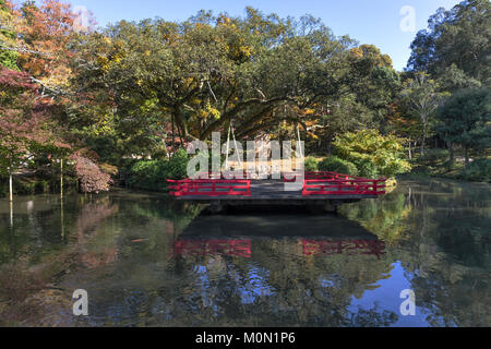 Nara, Japan, Nov. 10, 2017: A stage/platform with a small shrine under a tree on a lake in Nara Botanical Garden. Stock Photo