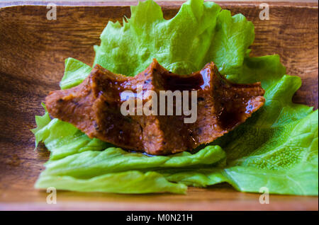 turkish food cig kofte with lemon and lettuce leaf  lettuce and parsley on wood plate tray Stock Photo