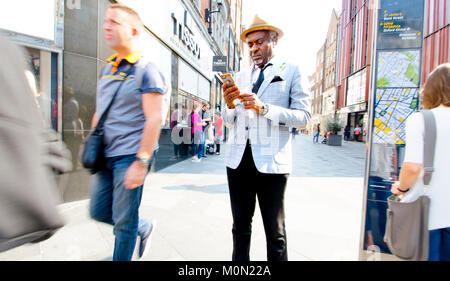 London, England, UK. Elderly black man using a mobile phone Stock Photo