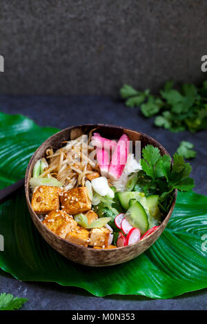 Vegan bowl with  silky tofu, bean sprouts and pickled vegetables over rice Stock Photo