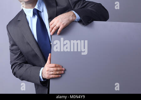 Young businessman standing near a blank board Stock Photo