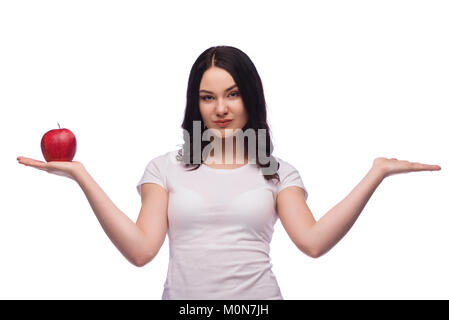 Brunette young girl holding red apple on the palm of her hand over white background Stock Photo