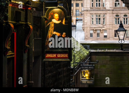 Pub signs for Jinglin Geordie and Halfway House pubs in dark alley, Fleshmarket Close, Edinburgh, Scotland, UK, with Balmoral Hotel in background Stock Photo