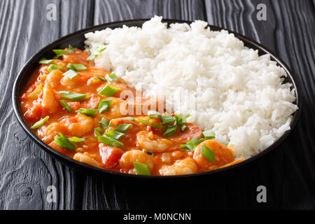 American cuisine: spicy gumbo with prawns, sausage and rice close-up on a plate on a table. horizontal Stock Photo