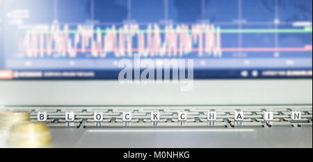 Dices with letters showing blockchain writing on laptop keyboard Stock Photo