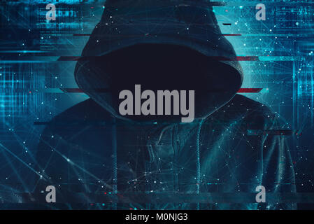 Cybersecurity, computer hacker with hoodie and obscured face, computer code overlaying image Stock Photo