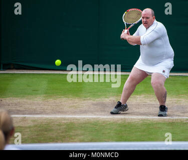 Kim Clijsters invitation doubles invites Chris Quinn from the spectators giving him a skirt to wear. Stock Photo