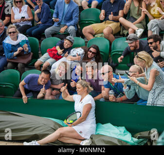 Kim Clijsters invitation doubles invites Chris Quinn from the spectators giving him a skirt to wear. Stock Photo