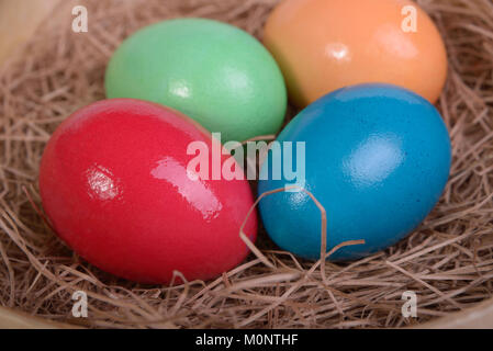Multi-colored Easter eggs on straw closeup Stock Photo