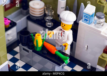 Tambov, Russian Federation - January 04, 2018 Lego chef cooking vegetables in the kitchen. Studio shot. Stock Photo