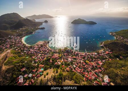 France,Caribbean,Lesser Antilles,Guadeloupe,Les Saintes,Terre-de-Haut,aerial view on the bay of the town of Terre-de-Haut,classified by UNESCO among the 10 most beautiful bays in the world,Basse-Terre background (aerial view) Stock Photo