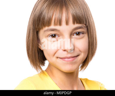 Attractive caucasian girl, isolated on white background. Schoolgirl smiling and looking at camera. Happy child in yellow t-shirt - emotional portrait  Stock Photo