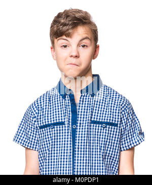 Teen boy making silly grimace - funny surprised face. Playful child isolated on white background. Emotional portrait of caucasian teenager looking at  Stock Photo