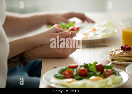 Couple holding hands enjoying healthy breakfast together, close  Stock Photo