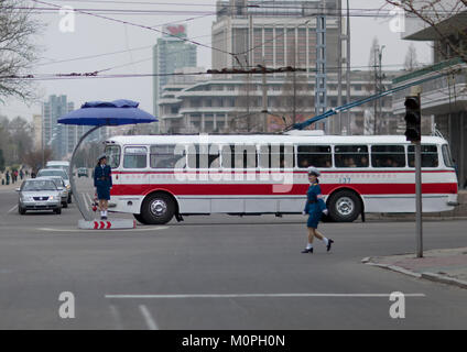 North Korean female traffic security officers in blue uniforms in a busy street, Pyongan Province, Pyongyang, North Korea Stock Photo