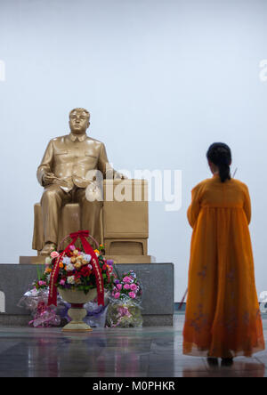 North Korean woman standing in front of a Kim il Sung golden statue in central history museum, Pyongan Province, Pyongyang, North Korea Stock Photo