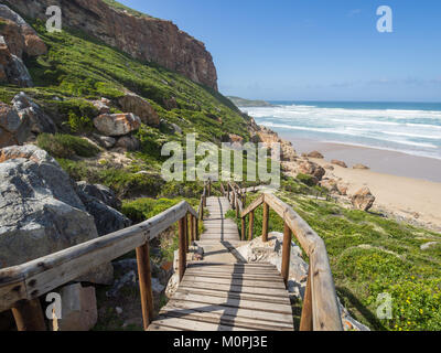 Garden Route - Robberg Nature Reserve - Wooden walkway leading down to beautiful beach and ocean on Robberg Island Stock Photo