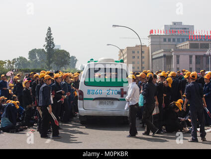 Ambulance passing in the middle of North Korean teenagers during the ...