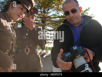 North Korean soldiers watching the camera screen of a tourist, Ryanggang Province, Samjiyon, North Korea Stock Photo