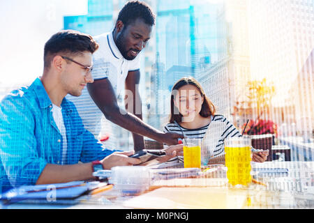 Happy afro-american man discussing work with his team Stock Photo