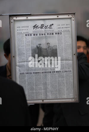 North Korean people reading the offical state newspaper in a metro station, Pyongan Province, Pyongyang, North Korea Stock Photo