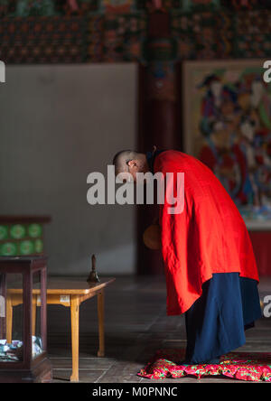 North Korean monk praying in Pohyon-sa Korean buddhist temple, Hyangsan county, Mount Myohyang, North Korea Stock Photo