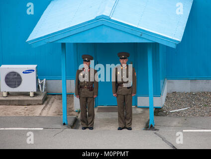 North Korean soldiers standing in front of the United Nations conference rooms on the demarcation line in the Demilitarized Zone, North Hwanghae Province, Panmunjom, North Korea Stock Photo