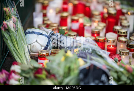 Luenen, Germany. 24th Jan, 2018. A soccer ball lying amidst candles and flowers at the Kaethe Kollwitz School in Luenen, Germany, 24 January 2018. A schoolchild is said to have killed one of his schoolmates. The 15-year old suspect was arrested on Tuesday morning according to the State Attorney General and the Dortmund Police. A judge is to decide whether the student is to be kept in custody. Credit: Guido Kirchner/dpa/Alamy Live News Stock Photo